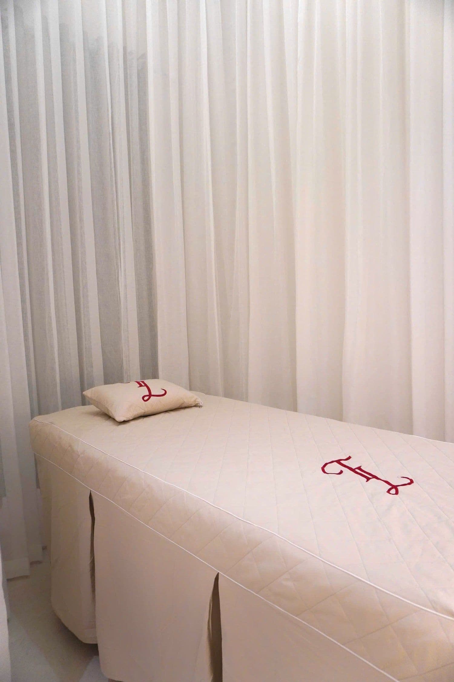 A massage table made up with crisp, fresh spa linens